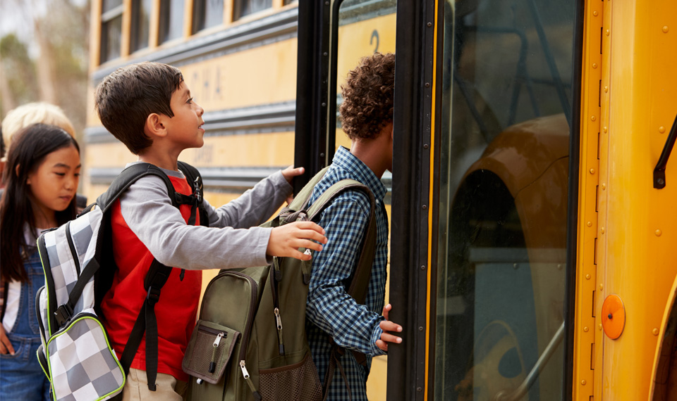 Students getting on a school bus.